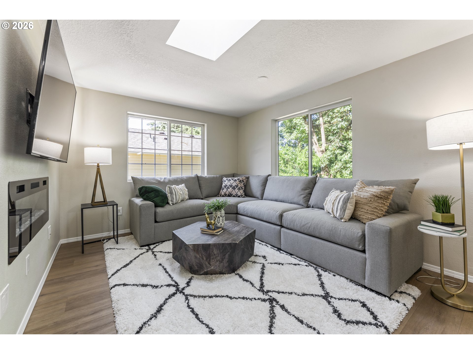 4024 Southeast 154th Place Portland, OR 97236 - Photo 6 of 43 a living room with furniture a large window and a wooden floor