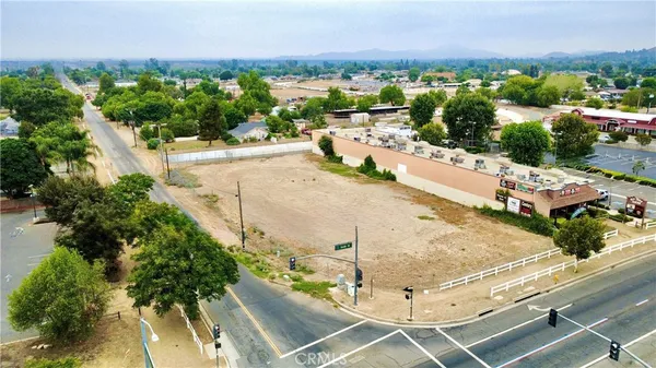 an aerial view of a house with a yard and lake view