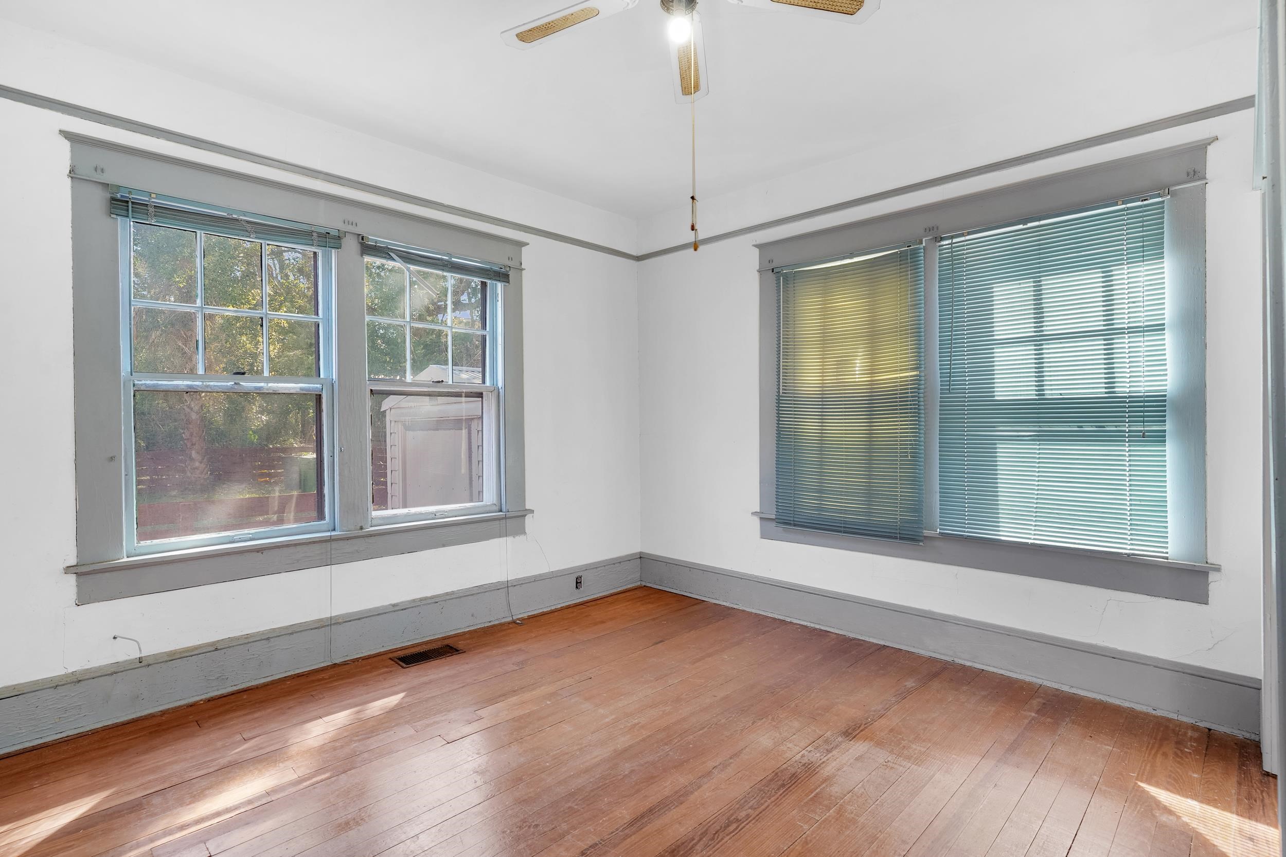 134 Washington Street St. Augustine, FL 32084 - Photo 16 of 41 an empty room with wooden floor and windows