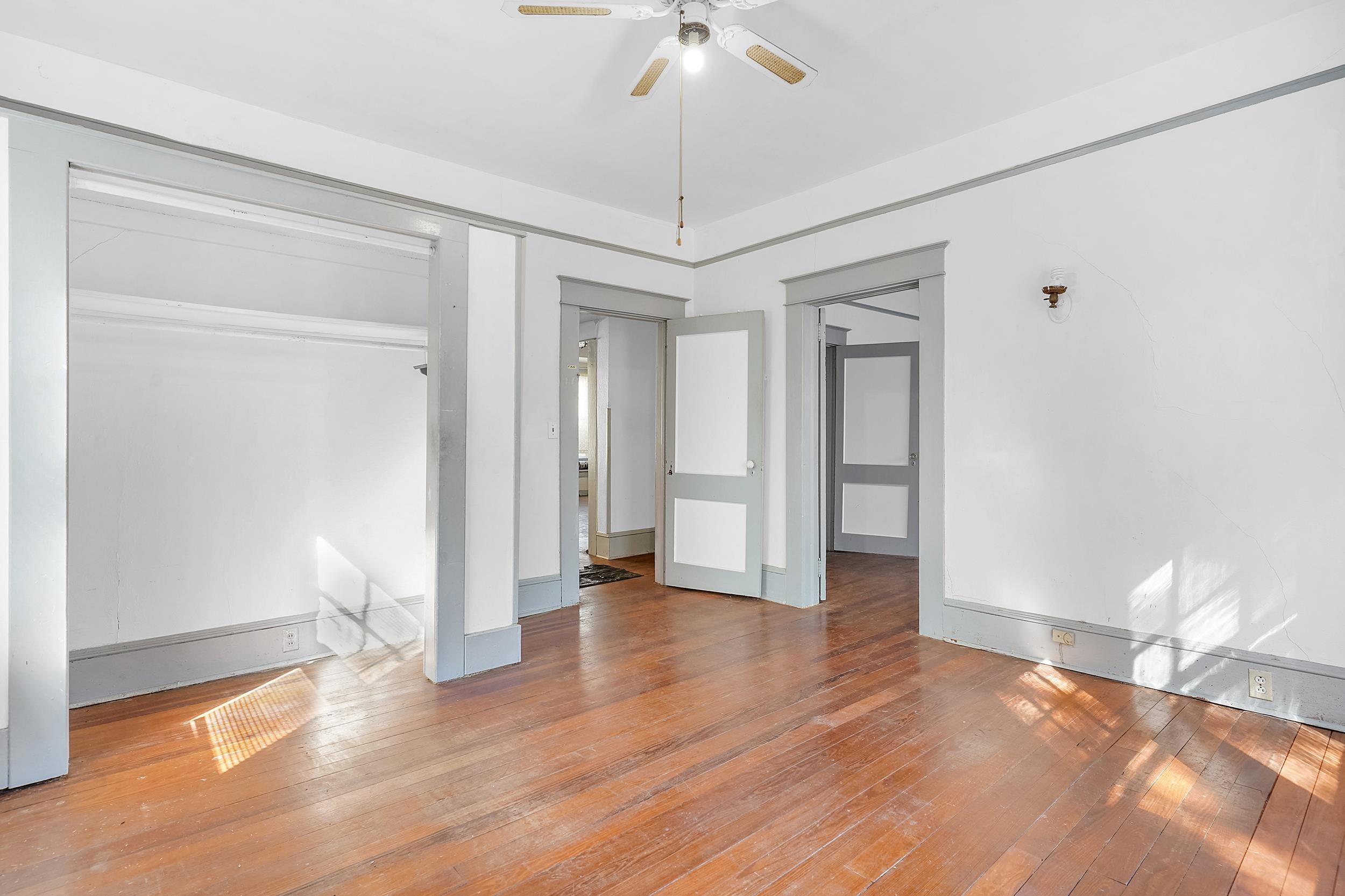 134 Washington Street St. Augustine, FL 32084 - Photo 16 of 41 Unfurnished bedroom with hardwood / wood-style flooring, a ceiling fan, and a closet