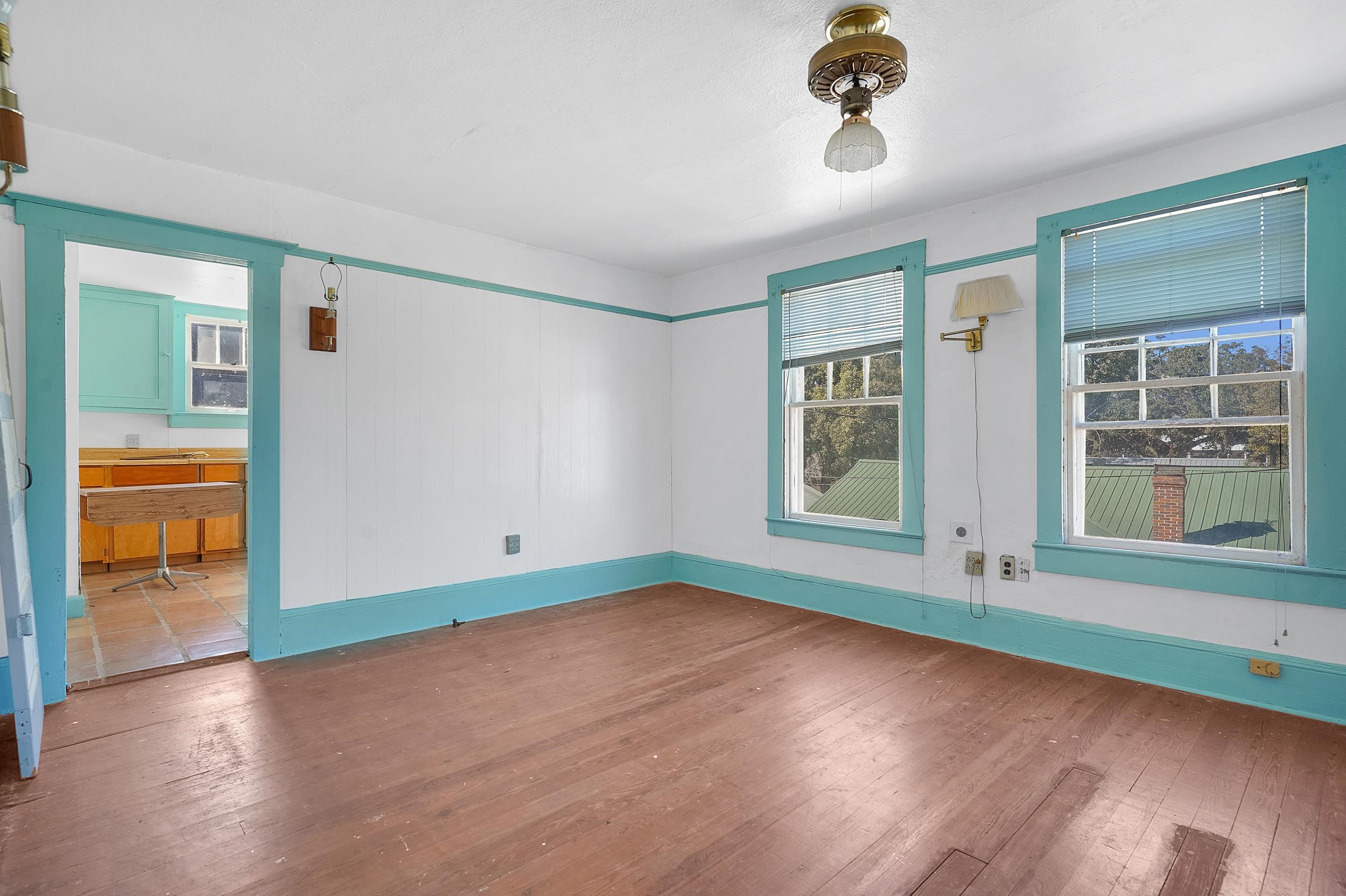 134 Washington Street St. Augustine, FL 32084 - Photo 25 of 41 an empty room with wooden floor and windows