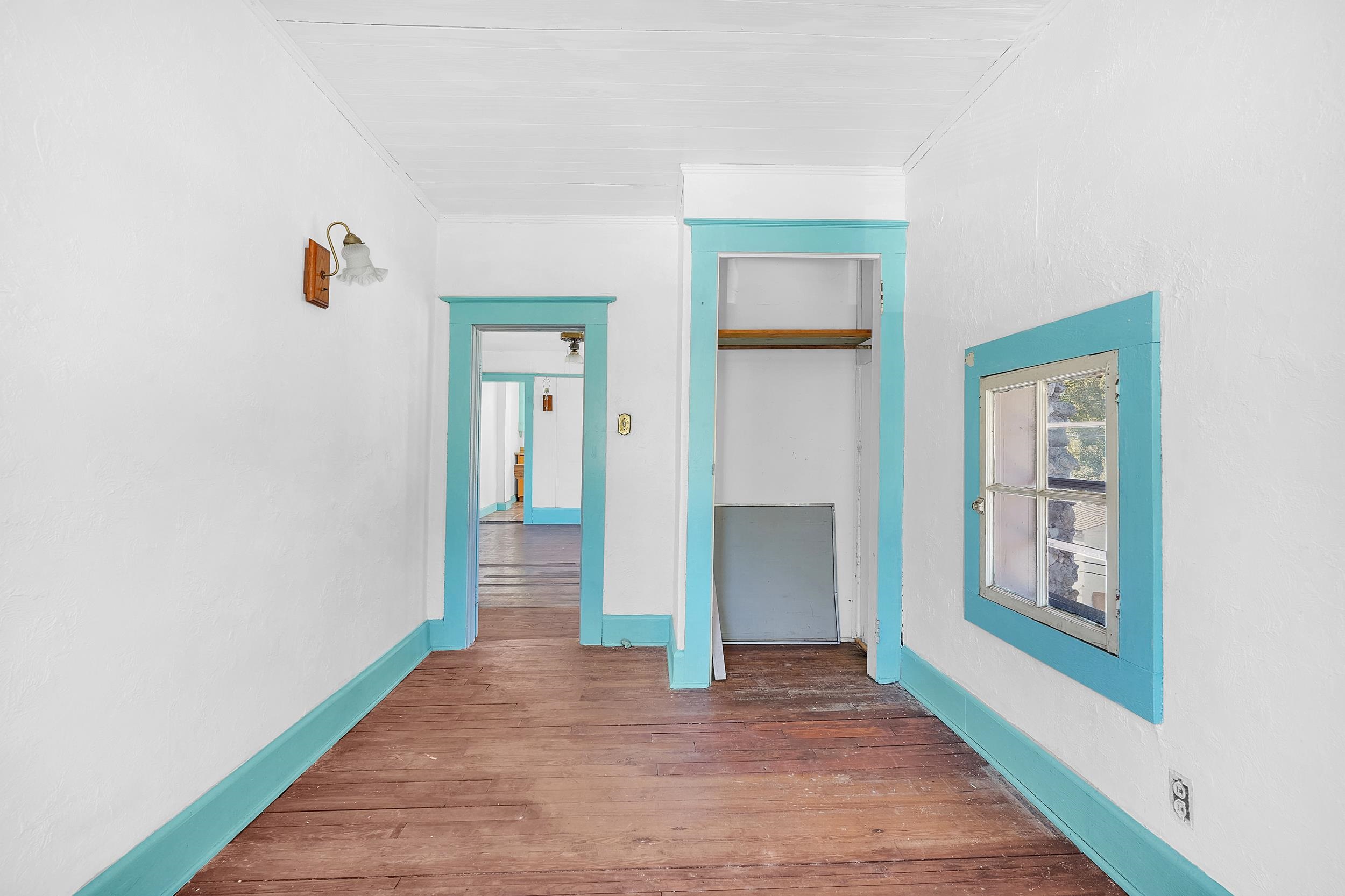 134 Washington Street St. Augustine, FL 32084 - Photo 27 of 41 Hallway featuring hardwood / wood-style floors and baseboards