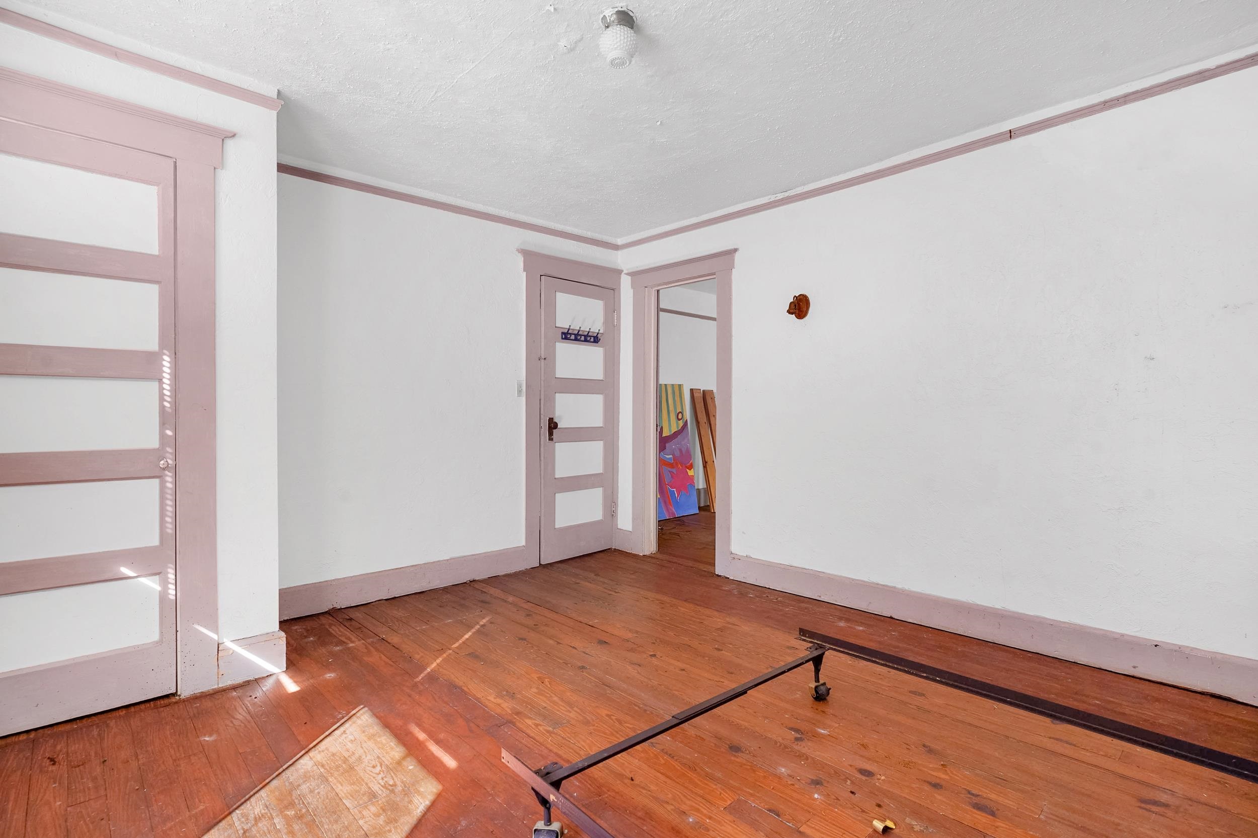 134 Washington Street St. Augustine, FL 32084 - Photo 33 of 41 Empty room featuring hardwood / wood-style flooring, a textured ceiling, and crown molding