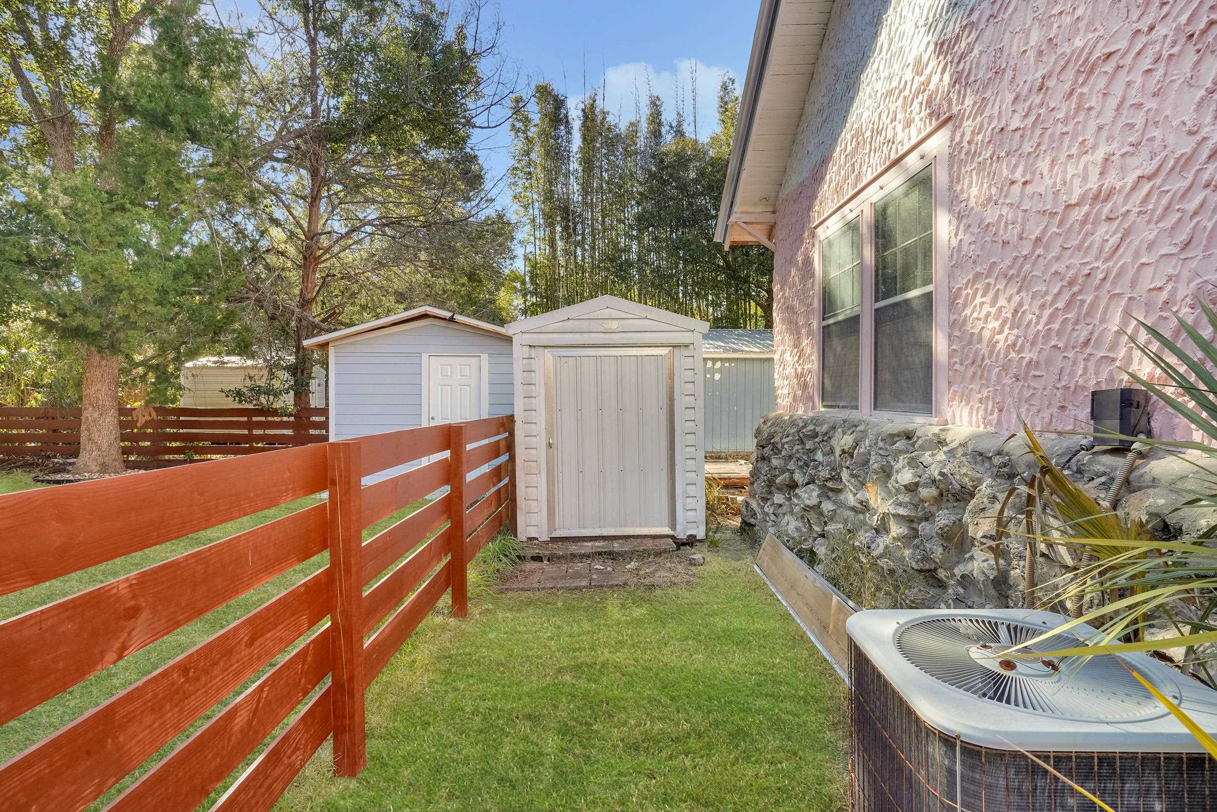 134 Washington Street St. Augustine, FL 32084 - Photo 37 of 41 Fenced yard featuring a storage unit