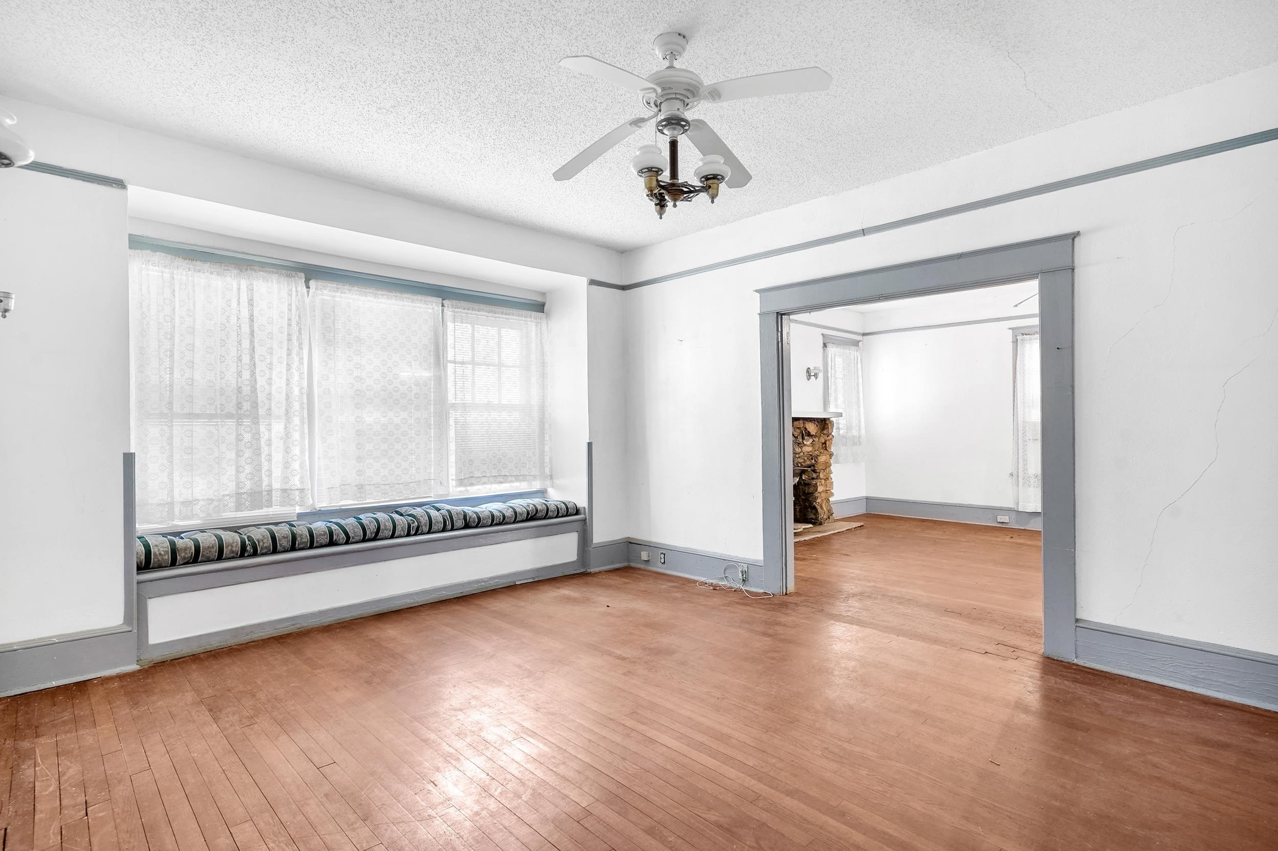 134 Washington Street St. Augustine, FL 32084 - Photo 5 of 41 Empty room featuring light wood-style floors, a ceiling fan, and a textured ceiling