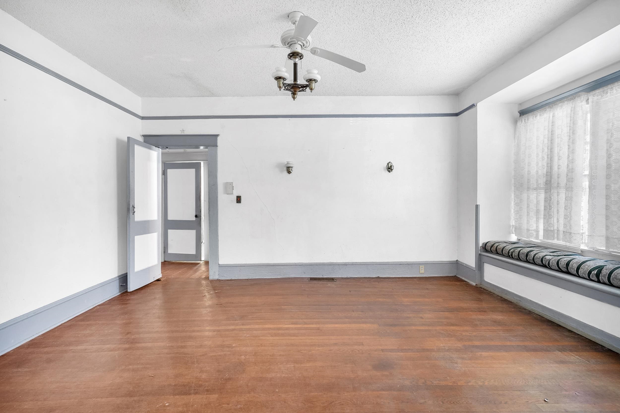 134 Washington Street St. Augustine, FL 32084 - Photo 10 of 41 Empty room with wood finished floors, ceiling fan, and a textured ceiling