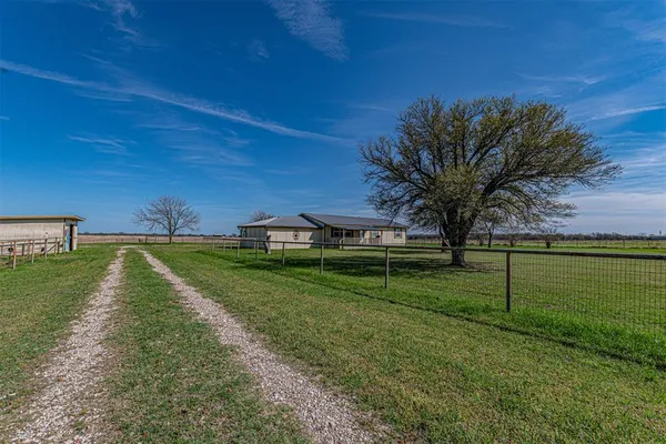 a view of a park with large trees