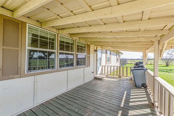 a view of a balcony with wooden floor