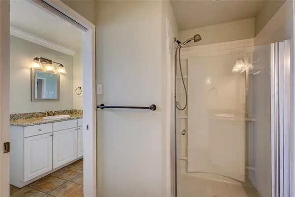 a bathroom with a granite countertop shower mirror and a sink