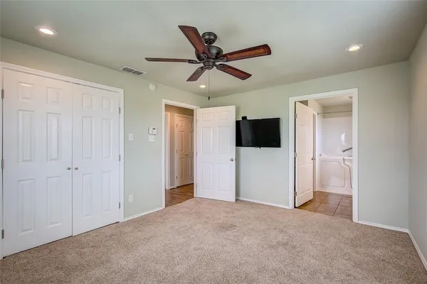 a living room with a ceiling fan and a window