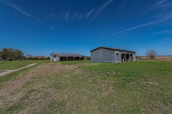 a backyard of a house with lots of green space and sink