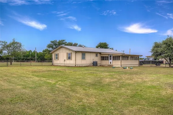 a front view of a house with a garden and deck