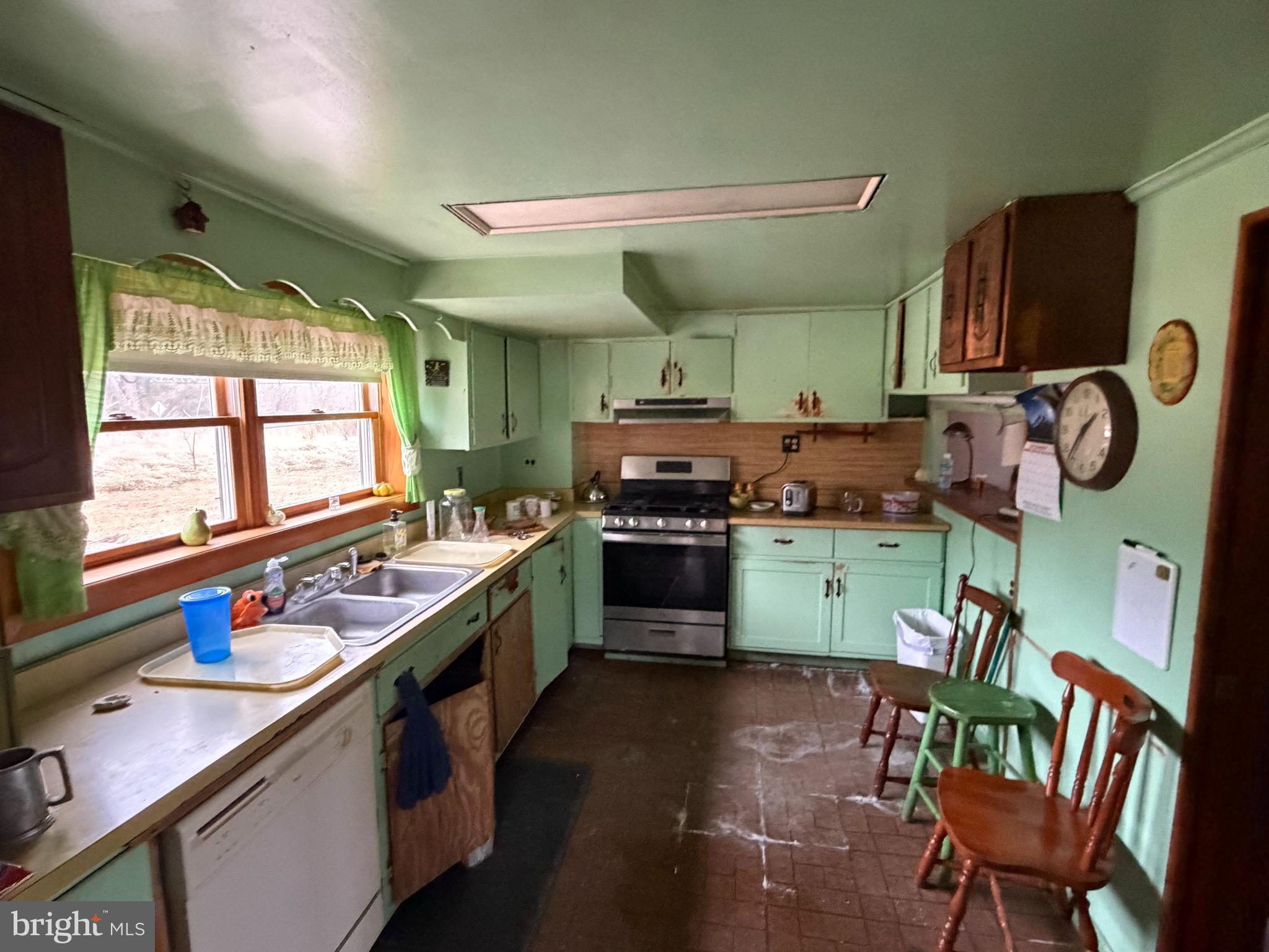 9163 Old Dumfries Road Catlett, VA 20119 - Photo 4 of 8 a kitchen with stainless steel appliances a stove a sink dishwasher and cabinets with wooden floor