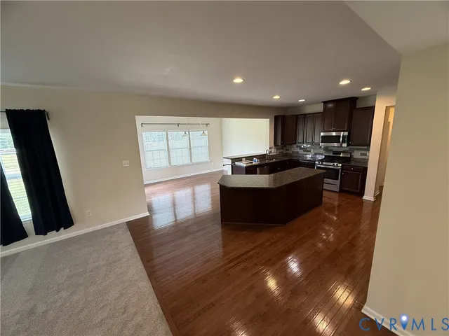 a kitchen with stainless steel appliances granite countertop a stove sink and cabinets