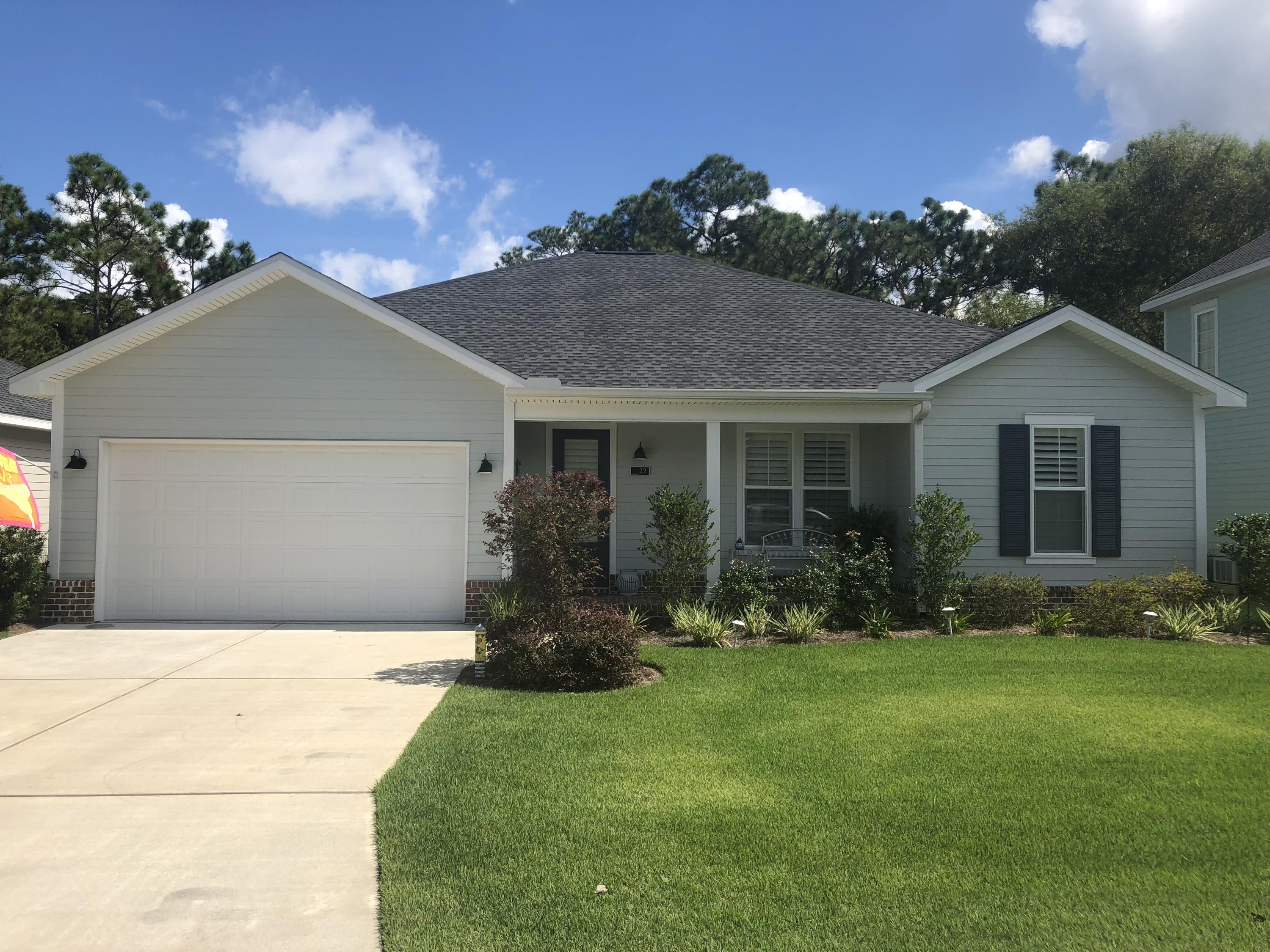 22 North Zander Way Santa Rosa Beach, FL 32459 - Photo 1 of 38 a front view of a house with garden