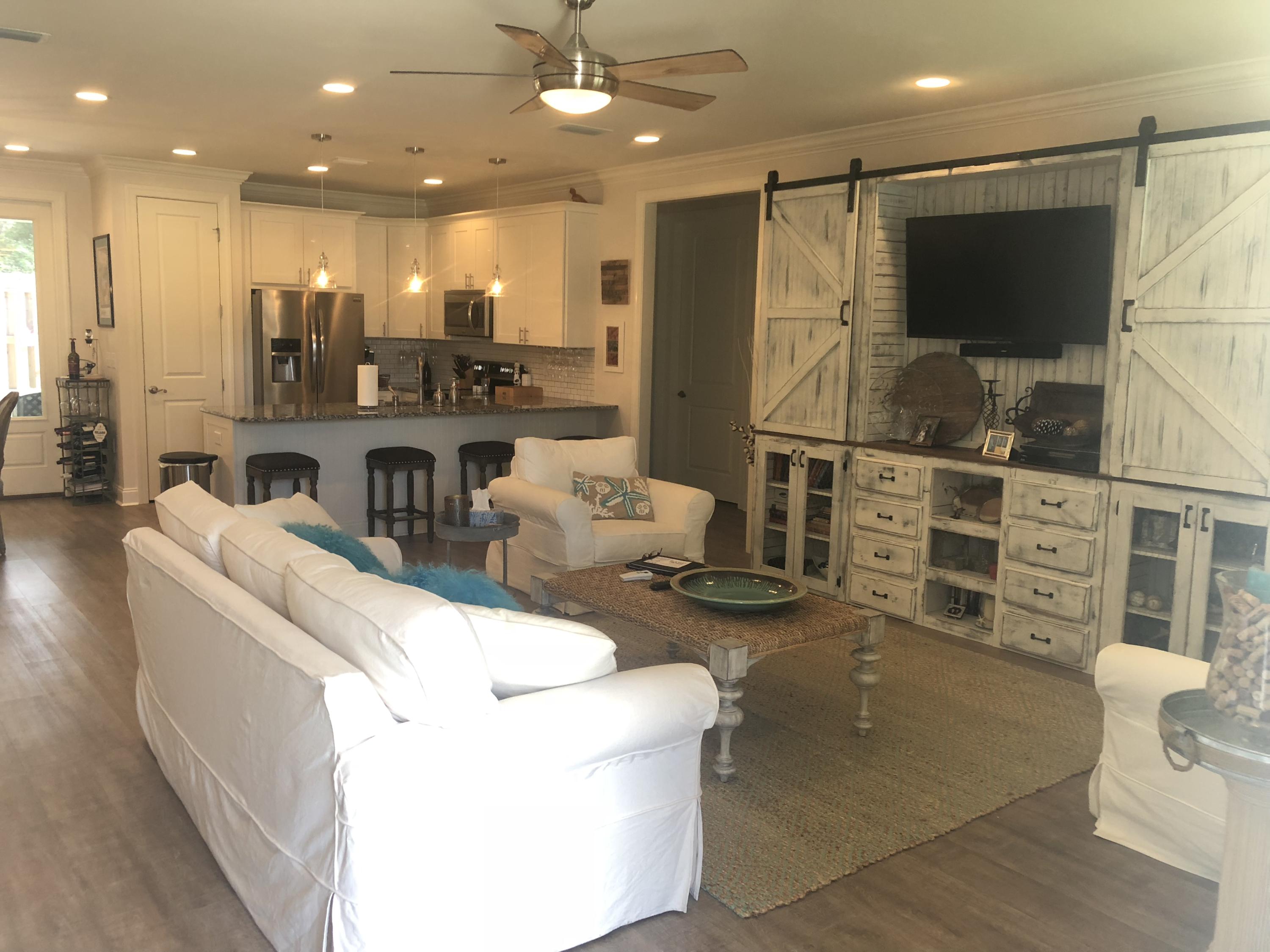 22 North Zander Way Santa Rosa Beach, FL 32459 - Photo 3 of 38 a living room with furniture a flat screen tv and kitchen view