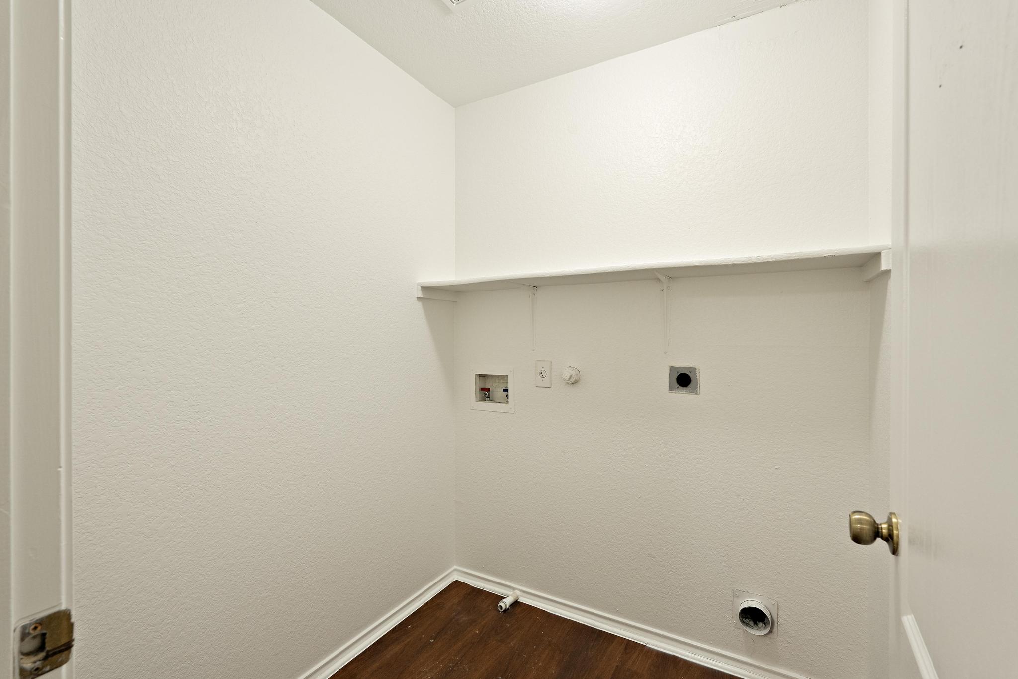 200 Lexington Kyle, TX 78640 - Photo 19 of 25 Washroom featuring gas dryer hookup, dark wood-style flooring, hookup for an electric dryer, hookup for a washing machine, and a textured wall
