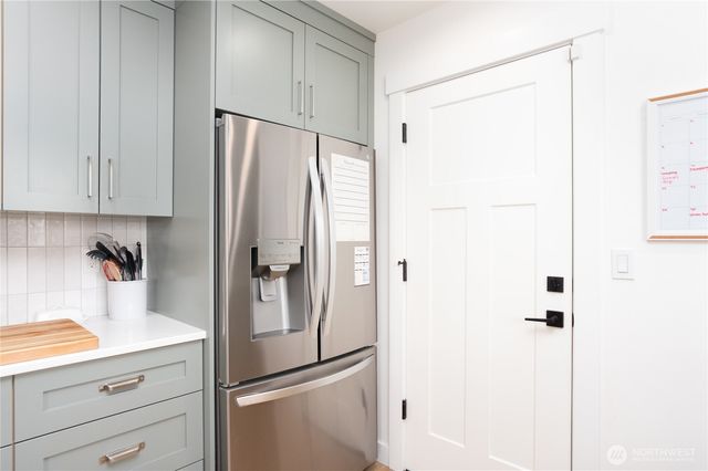 a kitchen with a refrigerator and cabinets