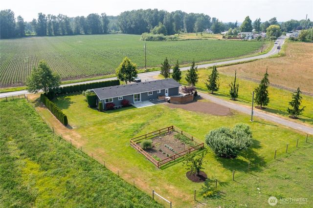 a view of a lake with a yard and large trees