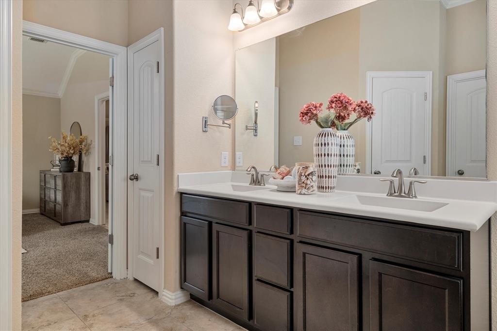 2413 Austin Lane Prosper, TX 75078 - Photo 12 of 32 a bathroom with a double vanity sink and a mirror