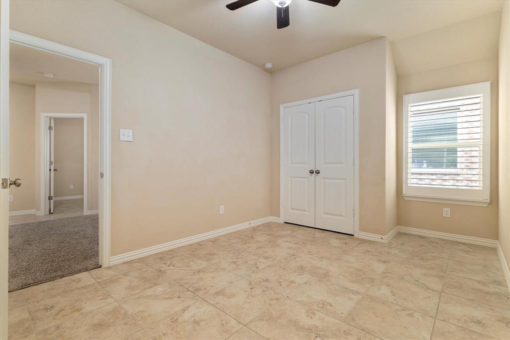 2413 Austin Lane Prosper, TX 75078 - Photo 16 of 32 an empty room with fan and windows