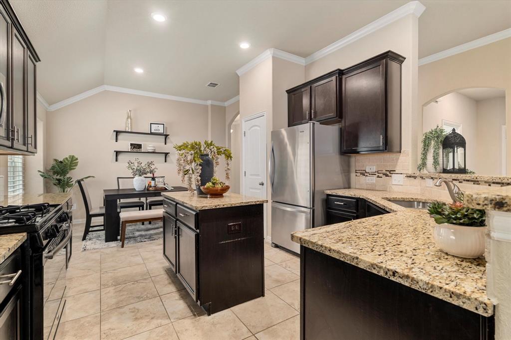 2413 Austin Lane Prosper, TX 75078 - Photo 3 of 32 a kitchen with refrigerator and chairs