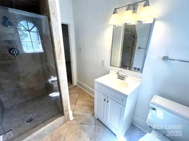 a bathroom with a sink a mirror and a shower