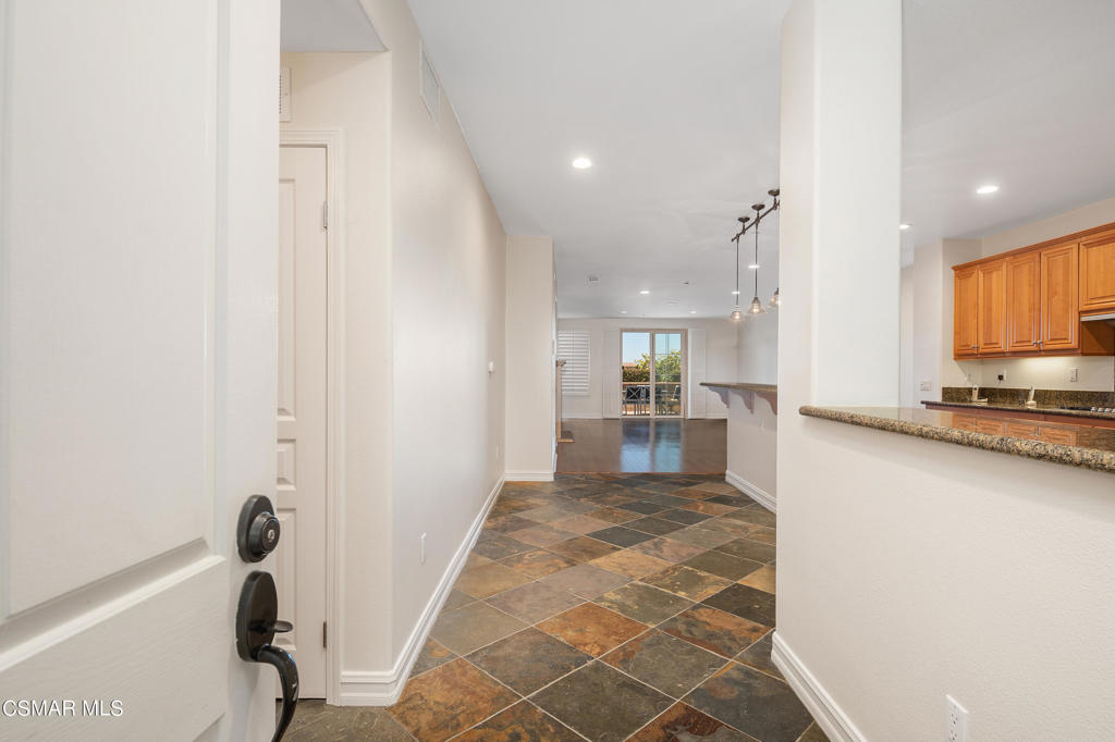 1415 Windshore Way Oxnard, CA 93035 - Photo 13 of 61 a view of a kitchen with kitchen island wooden floor center island and stainless steel appliances