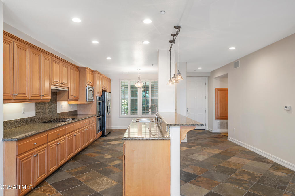 1415 Windshore Way Oxnard, CA 93035 - Photo 17 of 61 a large kitchen with kitchen island granite countertop a large counter top space a sink stainless steel appliances and cabinets