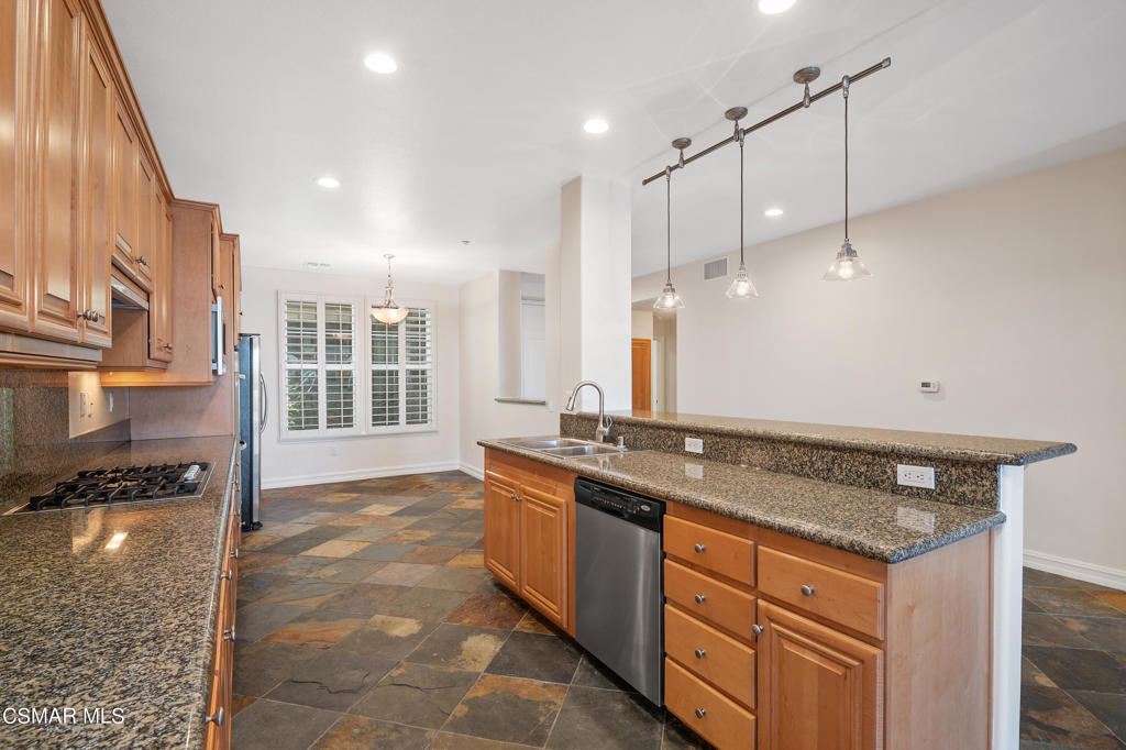 1415 Windshore Way Oxnard, CA 93035 - Photo 19 of 61 a kitchen with granite countertop a sink and cabinets