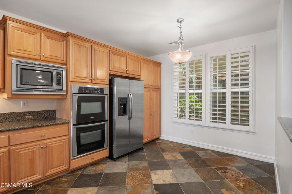 1415 Windshore Way Oxnard, CA 93035 - Photo 22 of 61 a kitchen with stainless steel appliances granite countertop a refrigerator oven cabinets a sink and a window