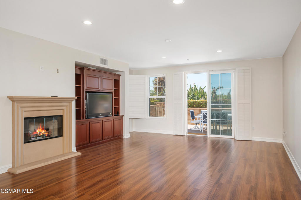 1415 Windshore Way Oxnard, CA 93035 - Photo 26 of 61 a view of an empty room with wooden floor fireplace and a window