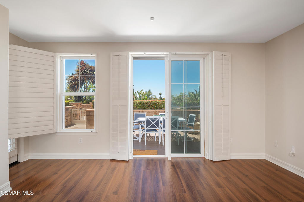 1415 Windshore Way Oxnard, CA 93035 - Photo 27 of 61 an empty room with wooden floor and windows