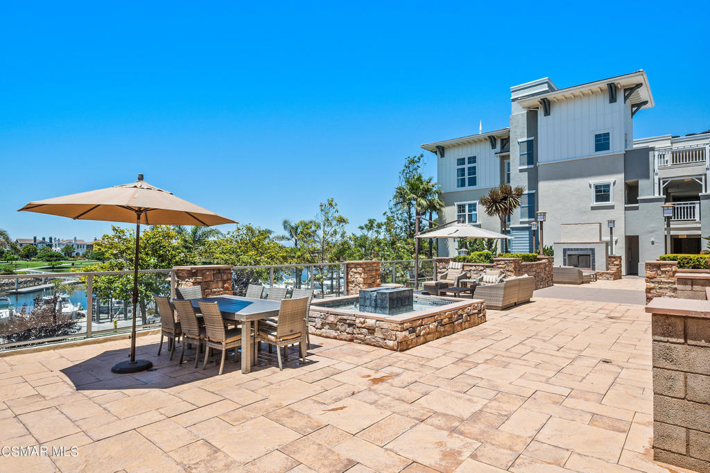 1415 Windshore Way Oxnard, CA 93035 - Photo 48 of 61 a view of a patio with a table and chairs under an umbrella