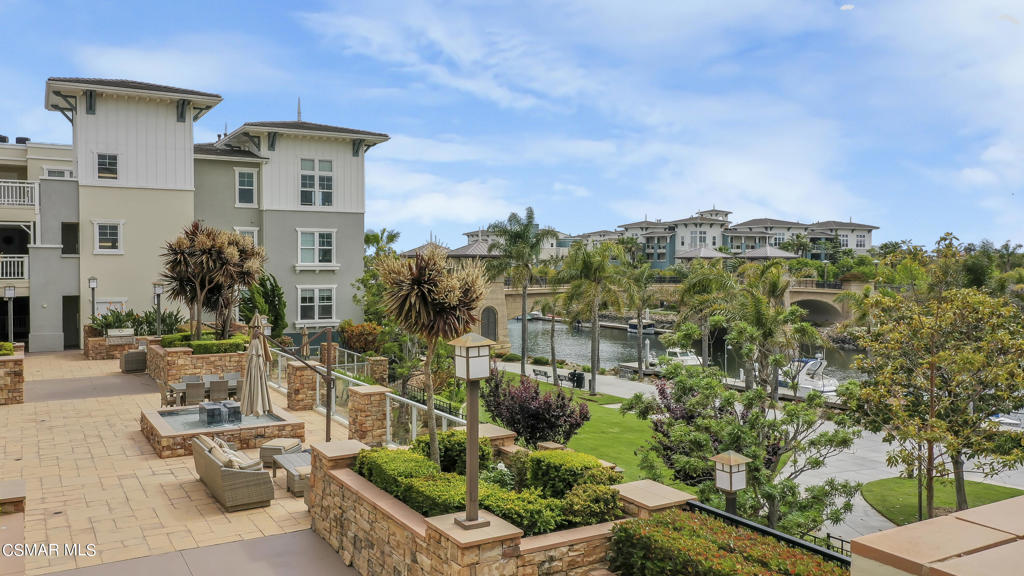 1415 Windshore Way Oxnard, CA 93035 - Photo 7 of 61 a front view of a house with a yard and fountain in front of it