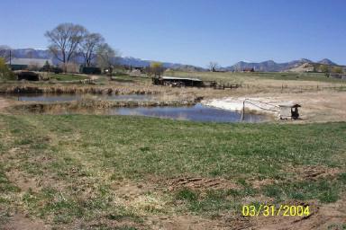 4395 233rd Road Rifle, CO 81650 - Photo 3 of 5 a view of a lake with houses in the back