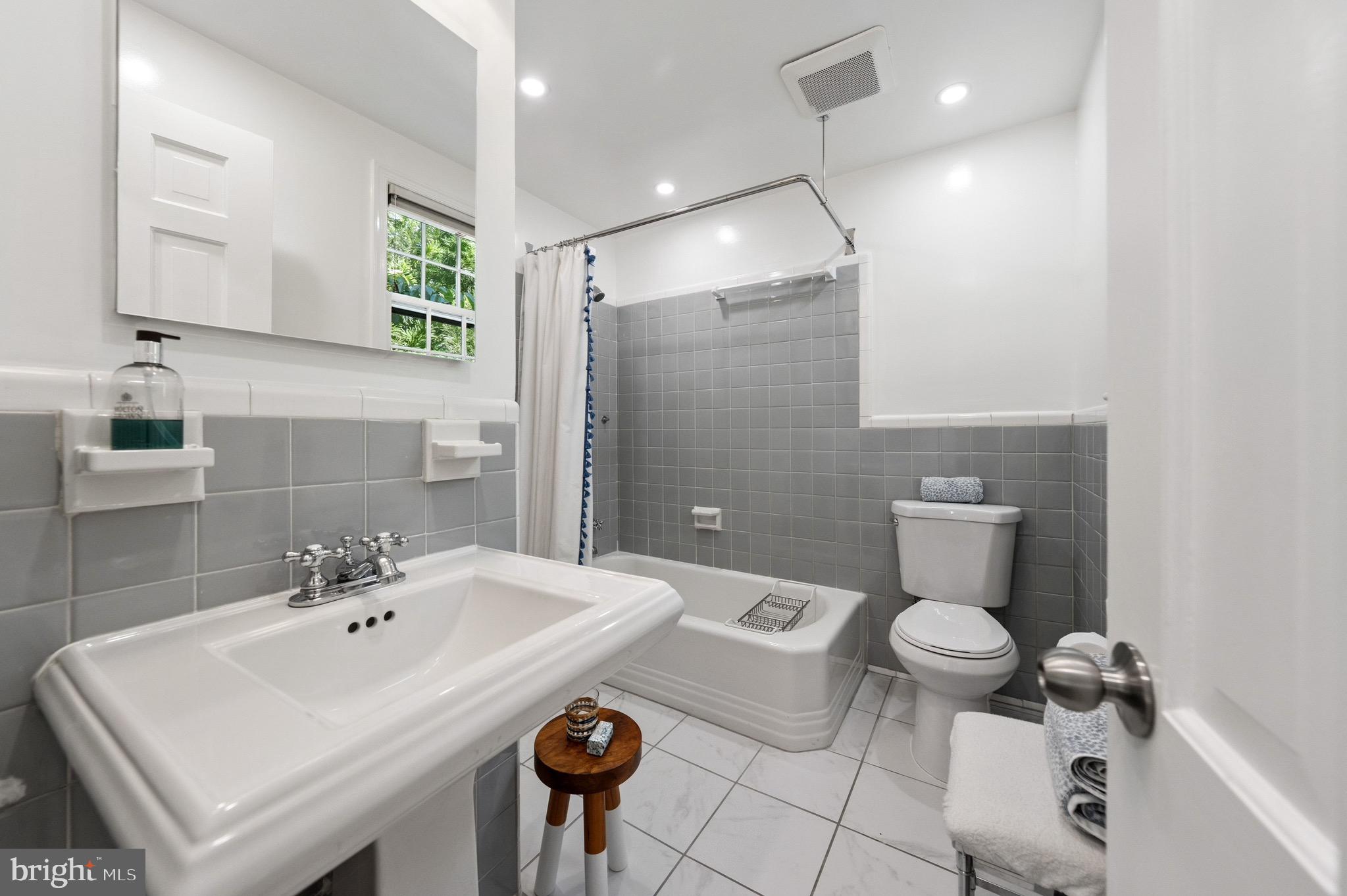 4555 W Street Northwest Washington, DC 20007 - Photo 24 of 34 a bathroom with a sink toilet and mirror