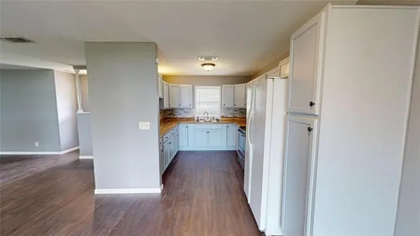 a view of a kitchen with wooden floor