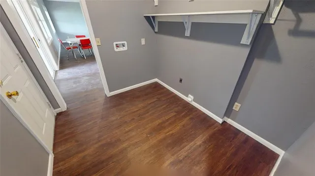 a view of hallway with wooden floor and stairs
