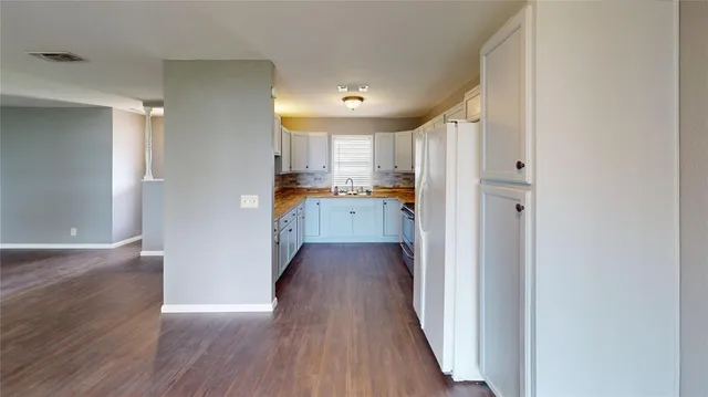 a view of a kitchen from the hallway
