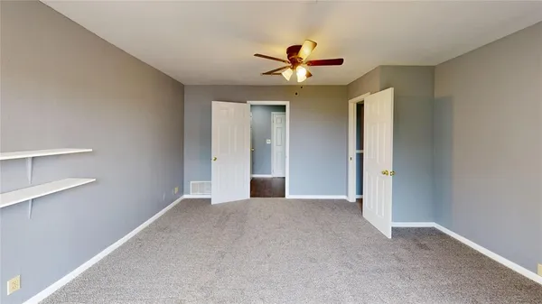 a view of a livingroom with a ceiling fan and window