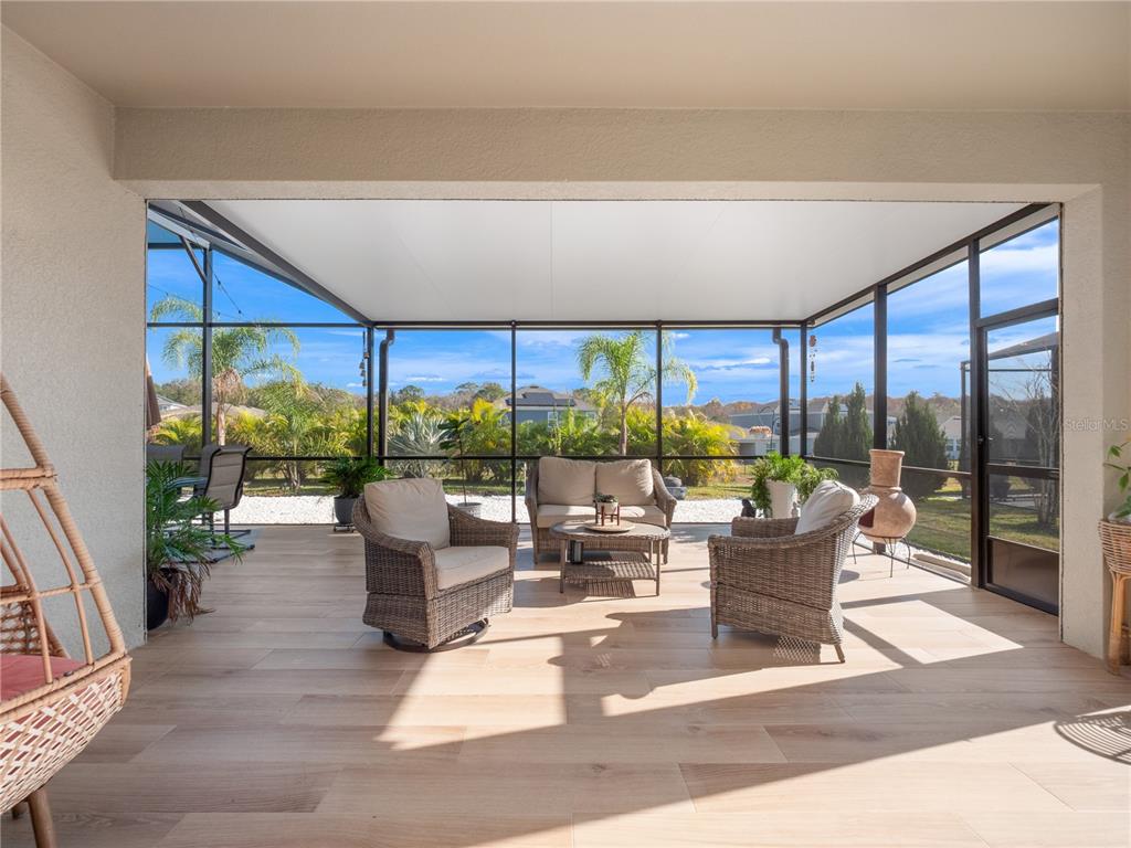 4531 Hillingdam Road Davenport, FL 33837 - Photo 2 of 36 a living room with patio furniture and garden view