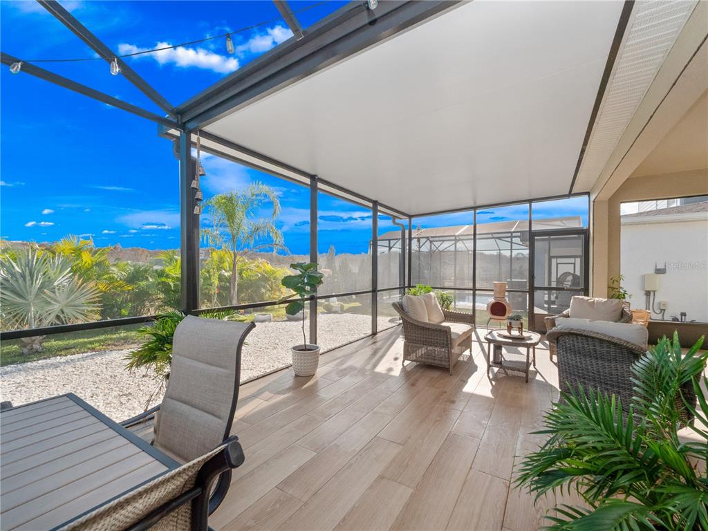 4531 Hillingdam Road Davenport, FL 33837 - Photo 25 of 36 a balcony with furniture and wooden floor