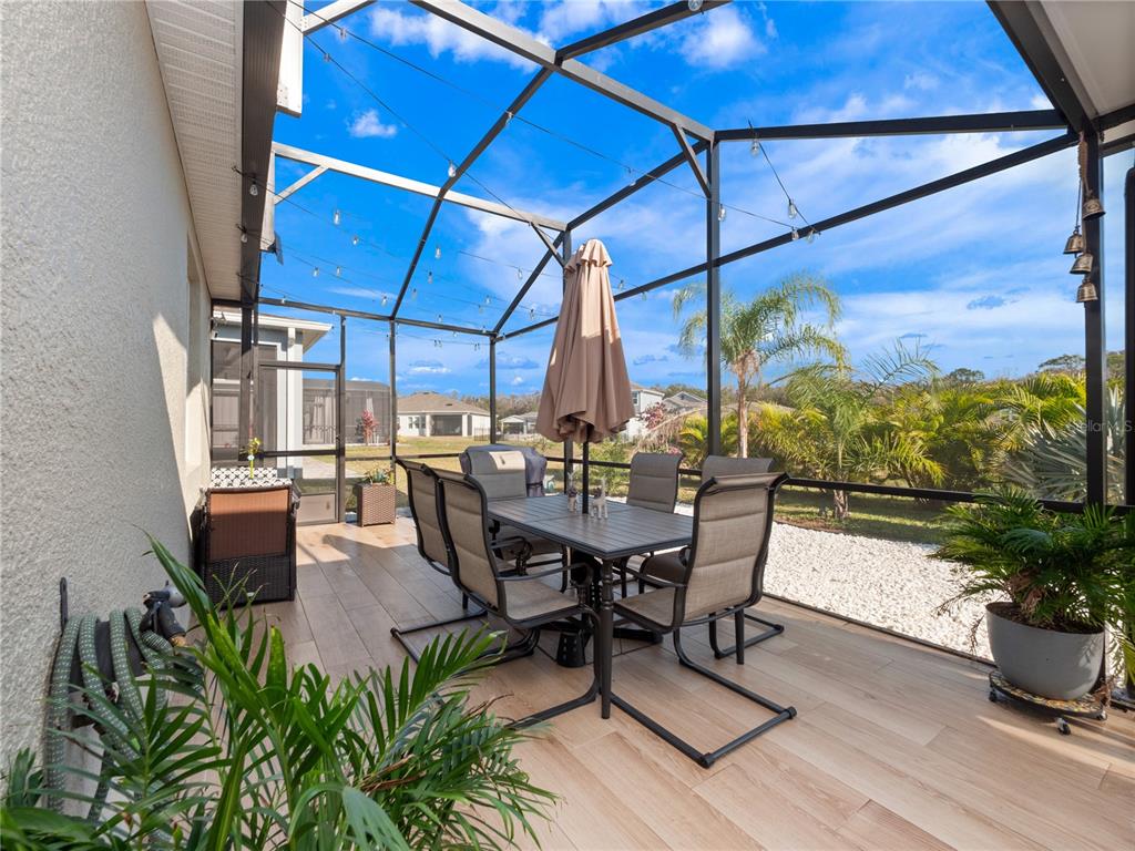 4531 Hillingdam Road Davenport, FL 33837 - Photo 26 of 36 a view of a dining table and chairs in the patio