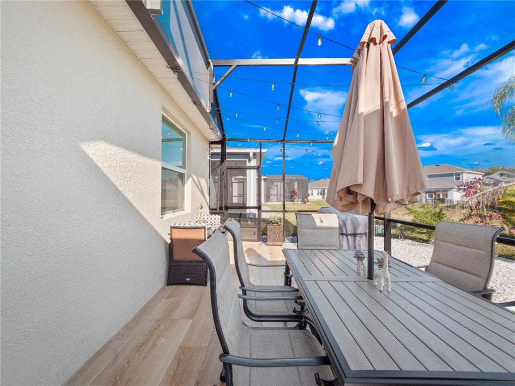 4531 Hillingdam Road Davenport, FL 33837 - Photo 27 of 36 a view of a dining room with furniture window and wooden floor