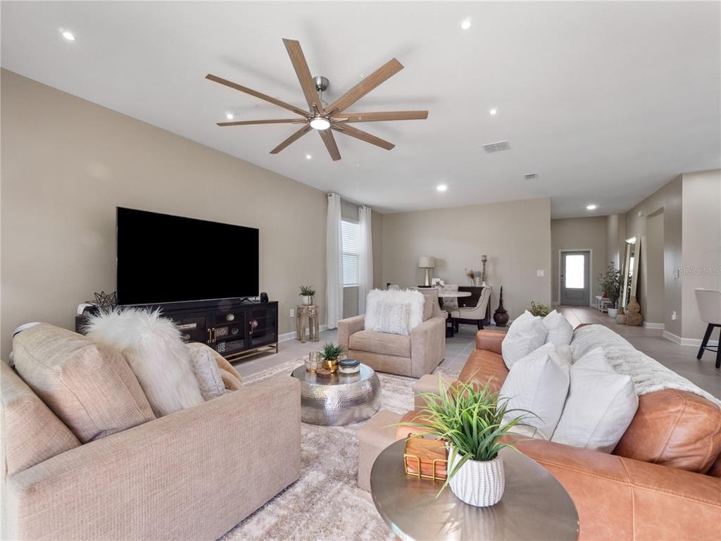 4531 Hillingdam Road Davenport, FL 33837 - Photo 4 of 36 a living room with furniture and a flat screen tv