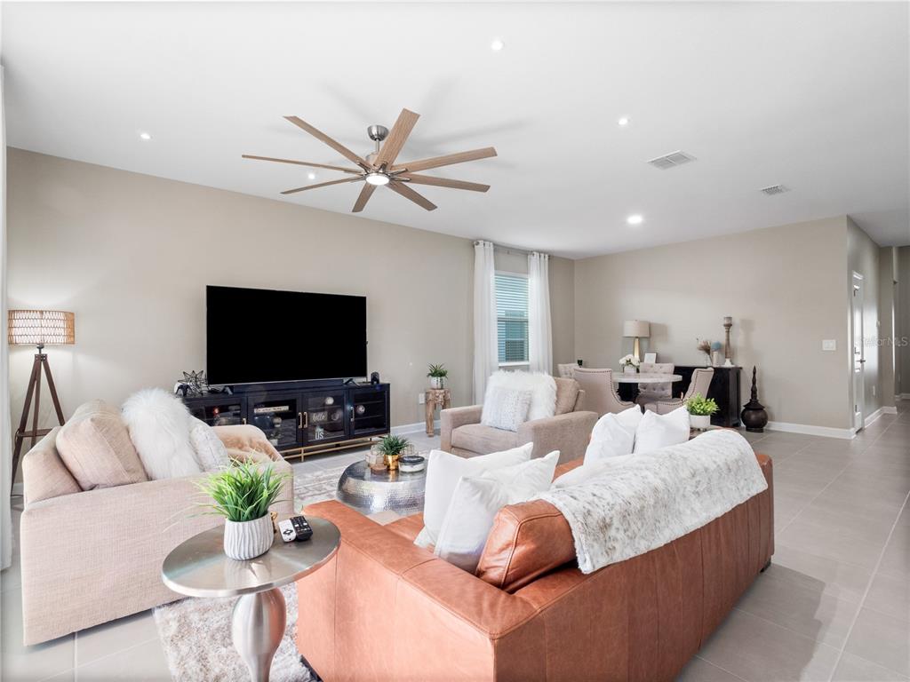 4531 Hillingdam Road Davenport, FL 33837 - Photo 5 of 36 a living room with furniture and a flat screen tv
