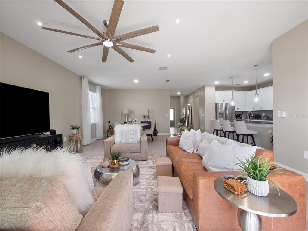4531 Hillingdam Road Davenport, FL 33837 - Photo 6 of 36 a living room with furniture kitchen view and a potted plant