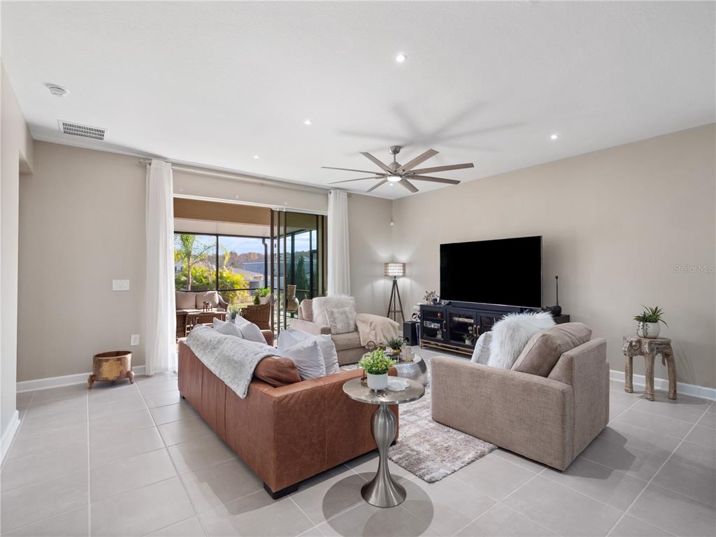 4531 Hillingdam Road Davenport, FL 33837 - Photo 7 of 36 a living room with furniture and a flat screen tv