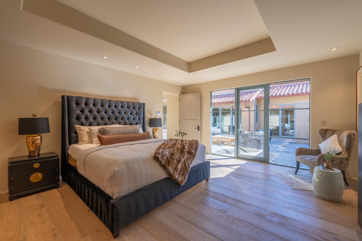 1014 Broncho Road Pebble Beach, CA 93953 - Photo 17 of 24 a bedroom with a bed and wooden floor